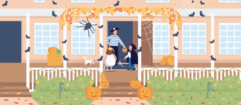 Trick-or-treaters in costume at a decorated front porch on Halloween night