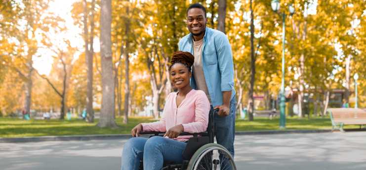 person in wheelchair being helped